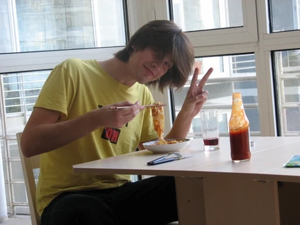 Philip eating pasta with chopsticks