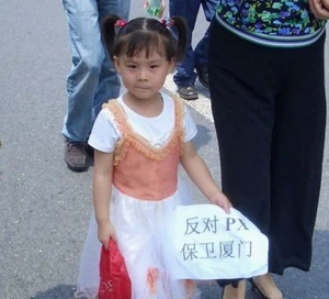 Small girl holding a sign